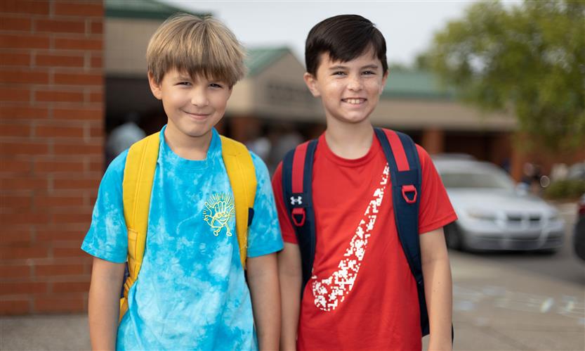 Two students smile
